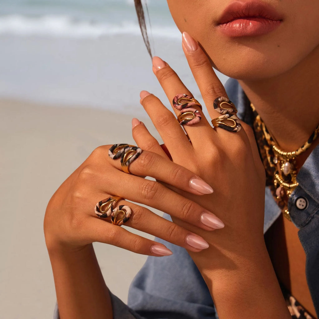 Stainless steel open mouth ring with leopard print and geometric designs including heart and star shapes