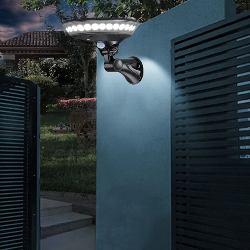 White outdoor solar security light with 360-degree LEDs and a motion sensor on a black mounting bracket.