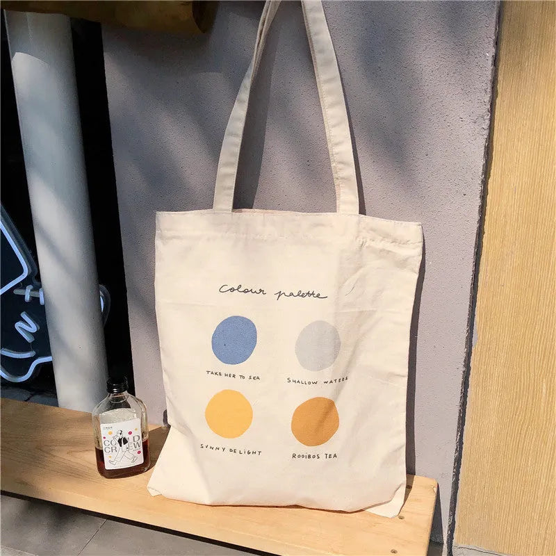 Women's printed canvas tote shopper bag with zipper, shown in light pink colour with geometric pattern.