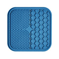 Silicone pet slow feeder licking pad in blue and orange with textured surface and scraper