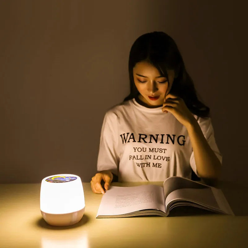 Pruixin PRX1363 rotating projector night light displaying star and moon patterns on a wall.