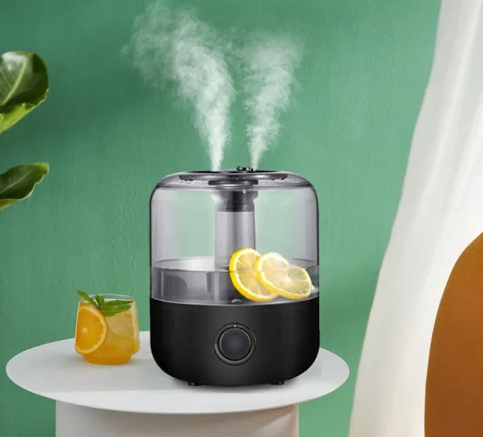 Black and white ultrasonic humidifier with 3 litre tank and aromatherapy function on bedside table