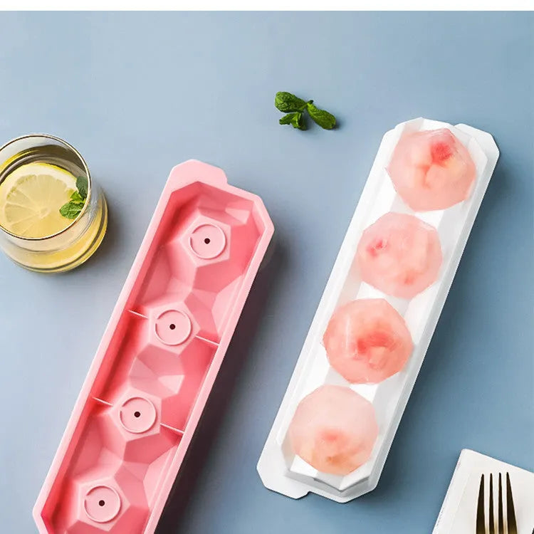 Silicone ice tray showing hockey puck shaped moulds alongside pentagon and spherical designs in light blue colour