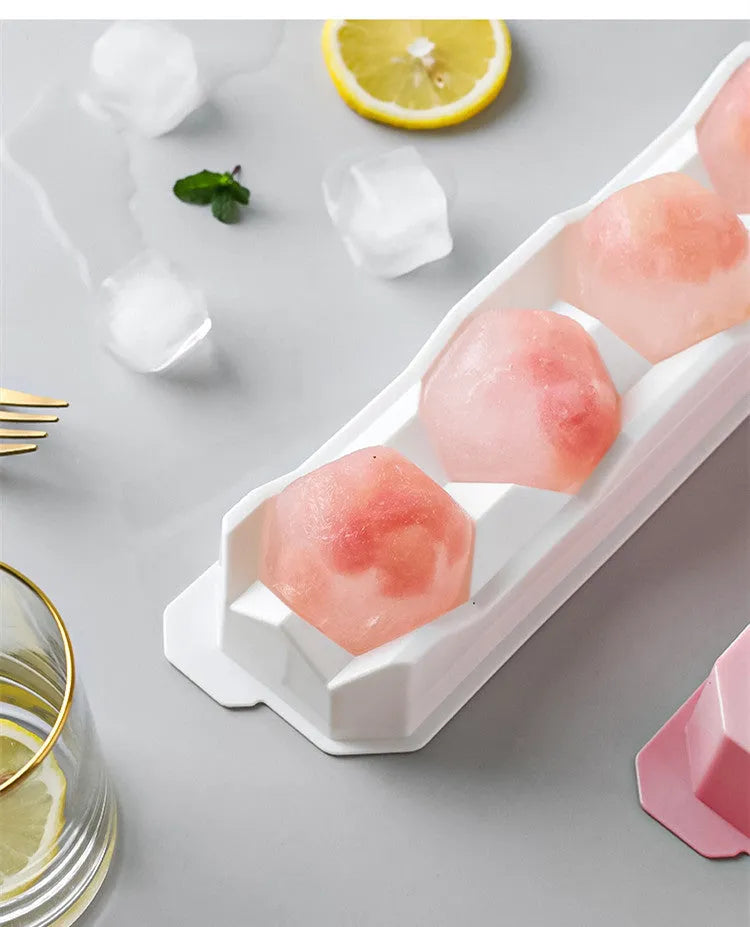 Silicone ice tray showing hockey puck shaped moulds alongside pentagon and spherical designs in light blue colour