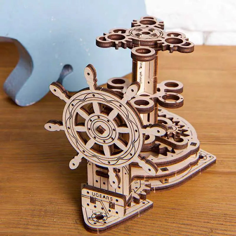 Ukrainian wooden rotating pen holder model showing steering wheel mechanism.