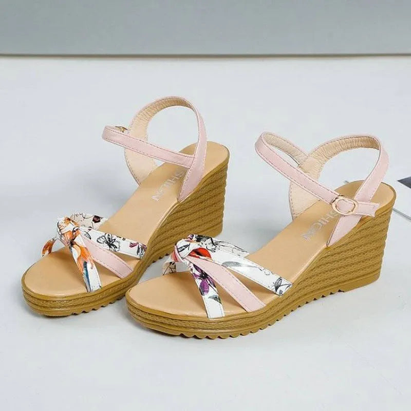 Women's pink wedge sandals with a thick heel, non-slip sole, and a single buckle strap.