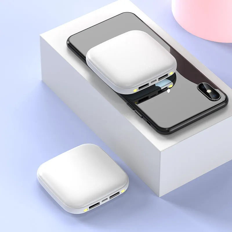 Compact black portable power bank with 20000mAh capacity and a small LED flashlight on its side.