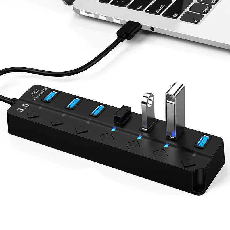 Black 7-port USB 3.0 hub with external power adapter showing seven USB ports