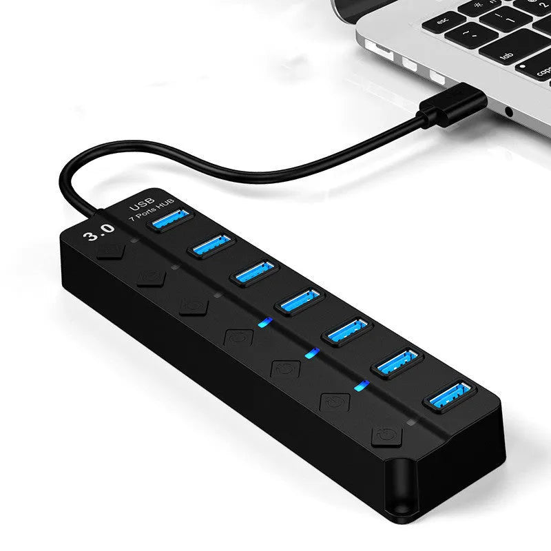 Black 7-port USB 3.0 hub with external power adapter showing seven USB ports