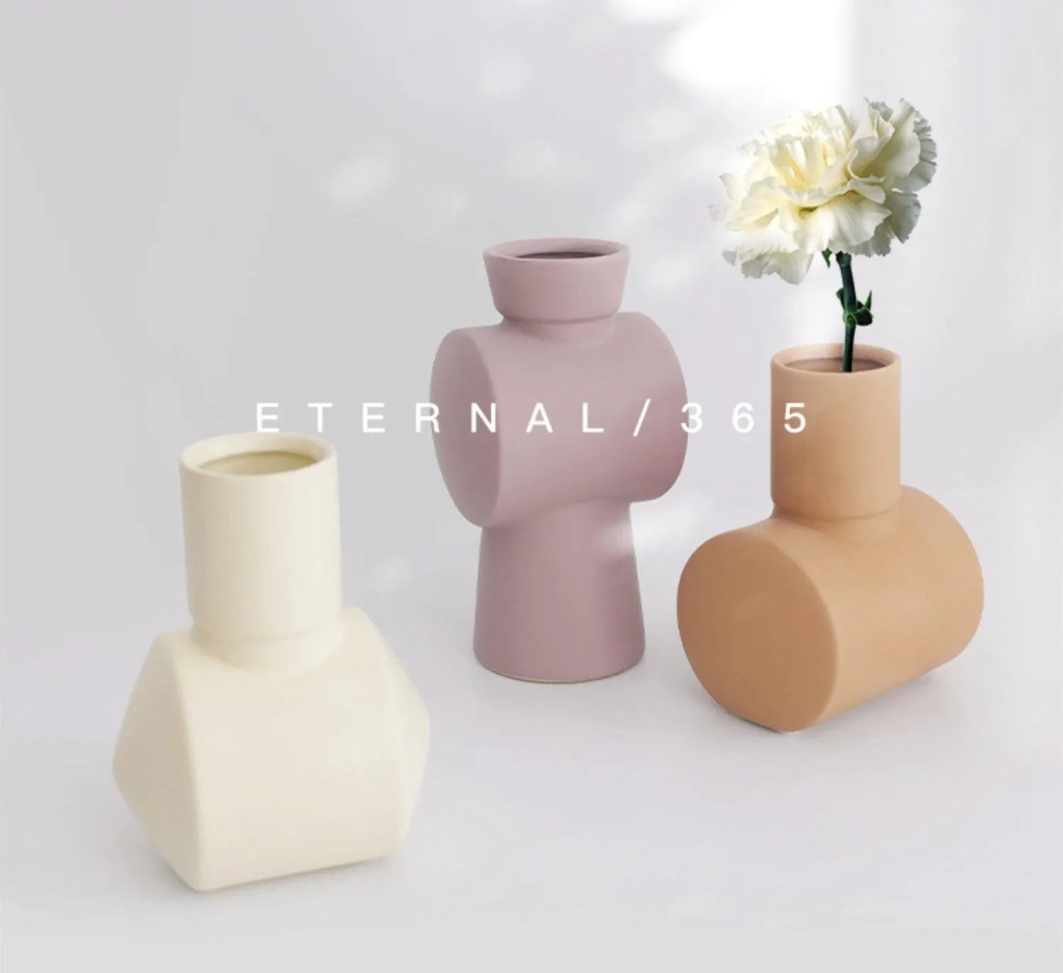 Nordic style ceramic vase with hammer texture glaze in beige, brown, or purple colours on a shelf.
