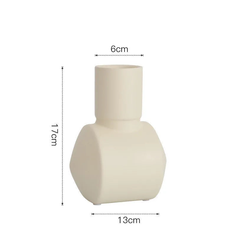 Nordic style ceramic vase with hammer texture glaze in beige, brown, or purple colours on a shelf.