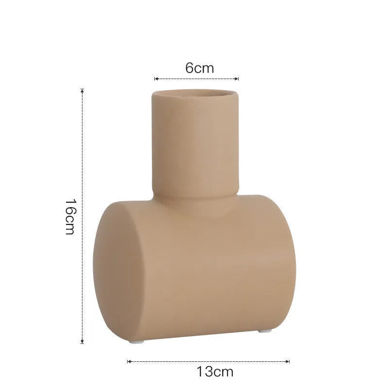 Nordic style ceramic vase with hammer texture glaze in beige, brown, or purple colours on a shelf.