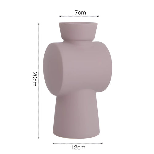 Nordic style ceramic vase with hammer texture glaze in beige, brown, or purple colours on a shelf.