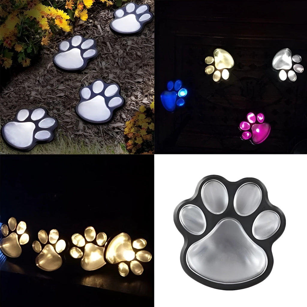Set of four black bear paw print solar LED garden lights with a central solar panel pole on grass.