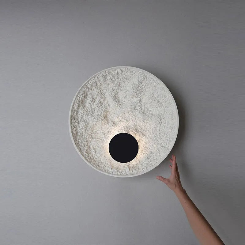 White modern iron wall lamp mounted on a wall, shown in two available sizes.
