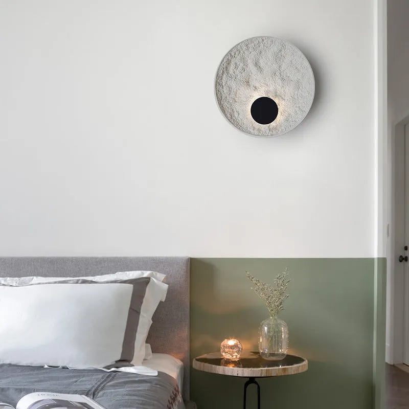 White modern iron wall lamp mounted on a wall, shown in two available sizes.