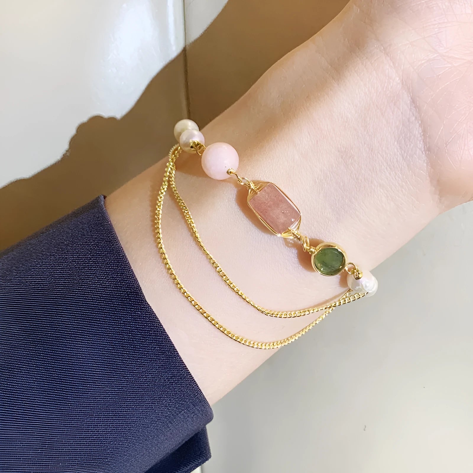 Women's pink bracelet with freshwater pearls and strawberry crystal charms in geometric design