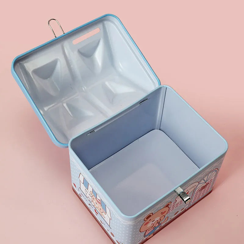 Blue house-shaped tinplate piggy bank with coin slot on desktop