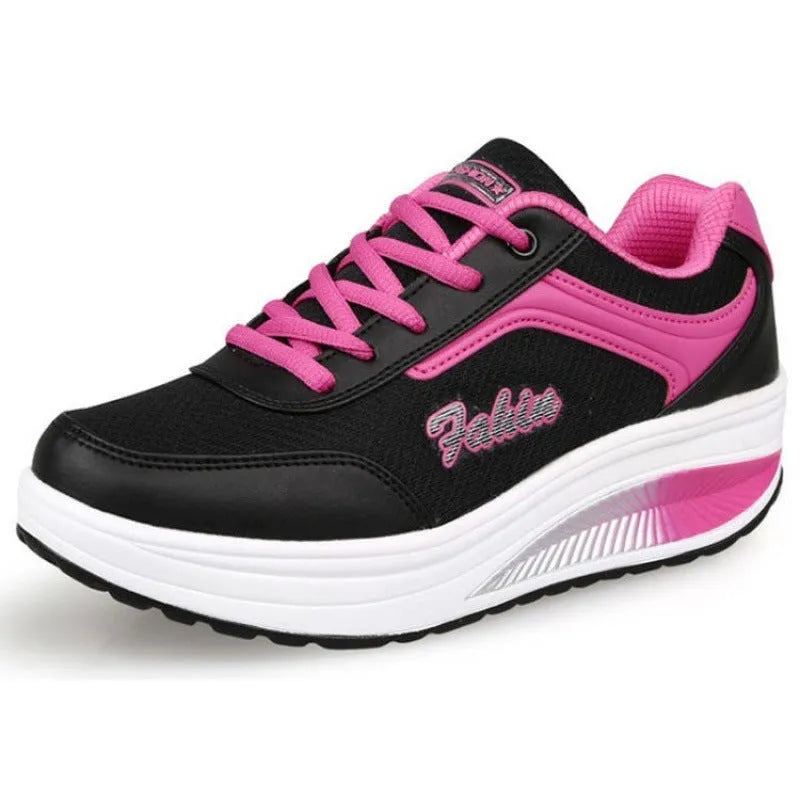 A pair of women's grey powder travel sports shoes with a mid-height heel on a white background.
