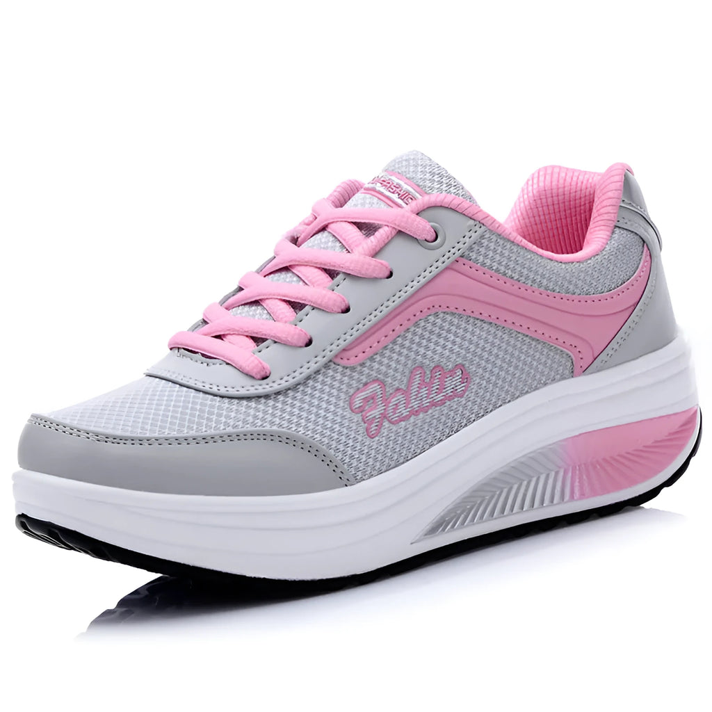 A pair of women's grey powder travel sports shoes with a mid-height heel on a white background.