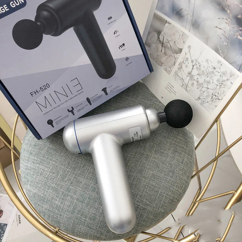 Grey fascia gun massager with USB charging port for muscle relaxation therapy