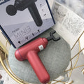 Grey fascia gun massager with USB charging port for muscle relaxation therapy