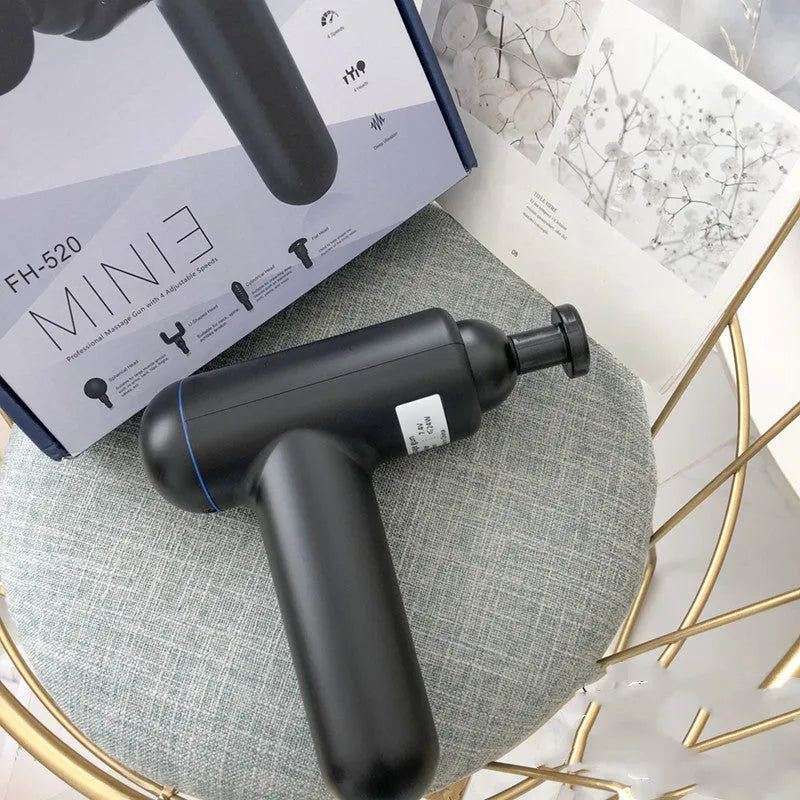 Grey fascia gun massager with USB charging port for muscle relaxation therapy