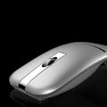 Crystal silver dual-mode Bluetooth wireless mouse with foldable ultra-thin design on a desk
