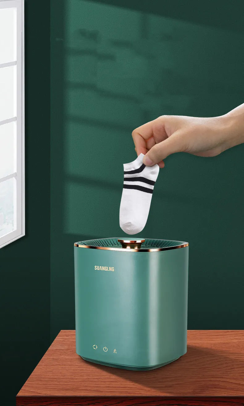 Green and white mini portable automatic washing machine for underwear and socks on a countertop.