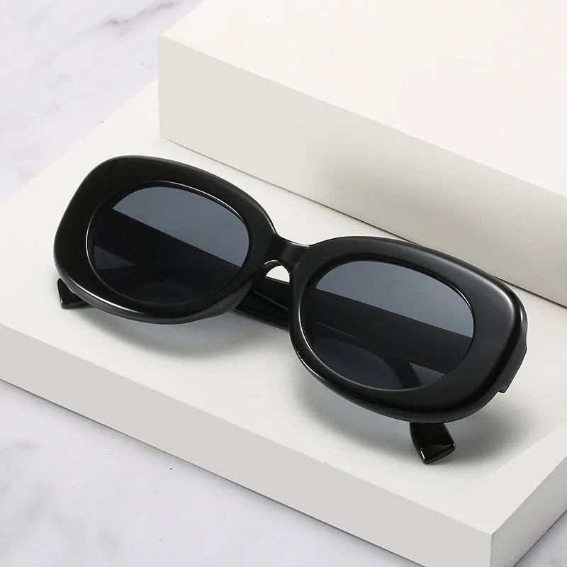 Women's oval fashion sunglasses with black frame and UV400 protection