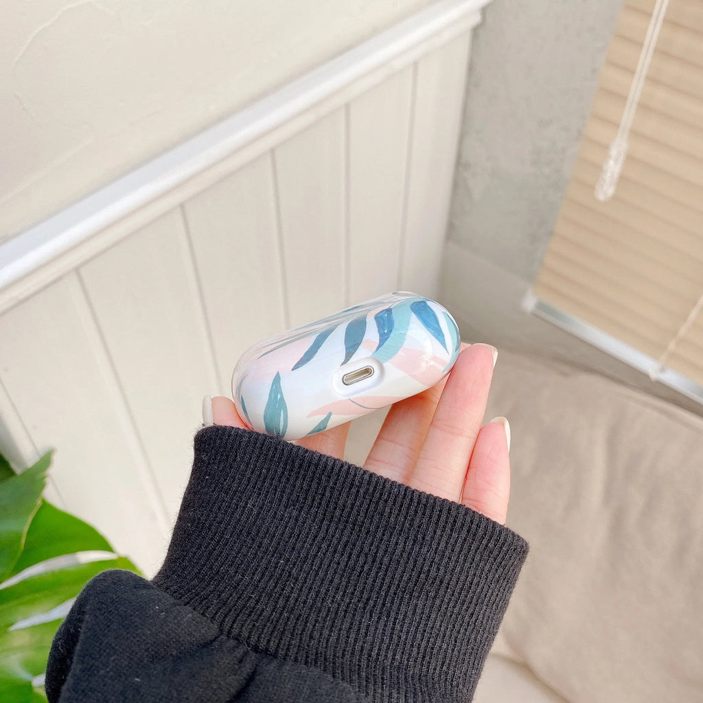 Blue and green banana leaves pattern AirPods protective case made from soft TPU material.