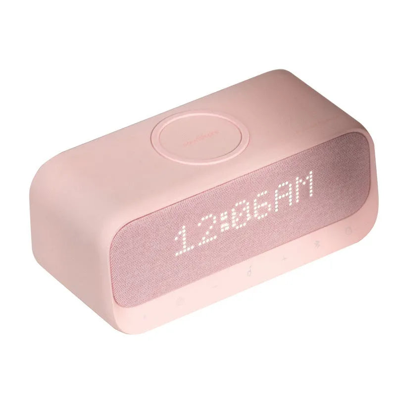 Anker Soundcore white Bluetooth speaker with wireless charging top and digital clock display.