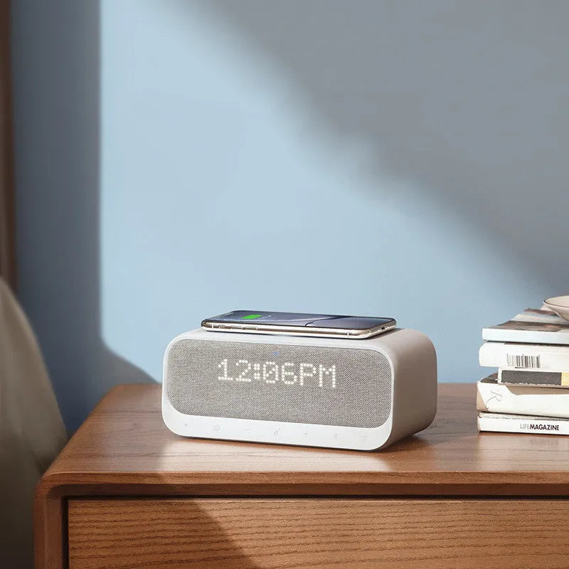 Anker Soundcore white Bluetooth speaker with wireless charging top and digital clock display.