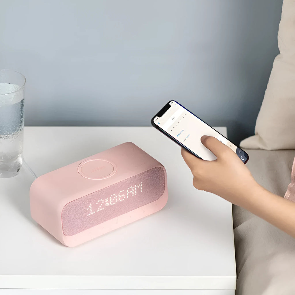 Anker Soundcore white Bluetooth speaker with wireless charging top and digital clock display.