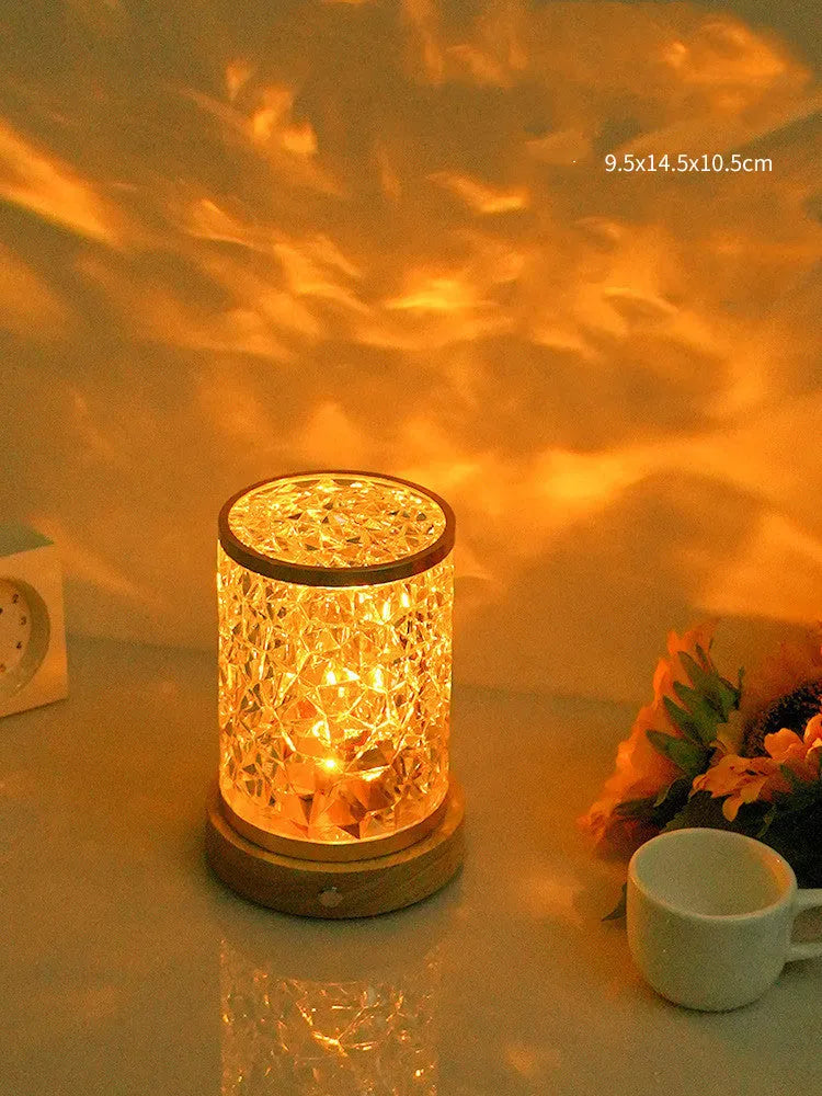 Modern rotating water ripple night light with acrylic body and solid wood base on a surface.