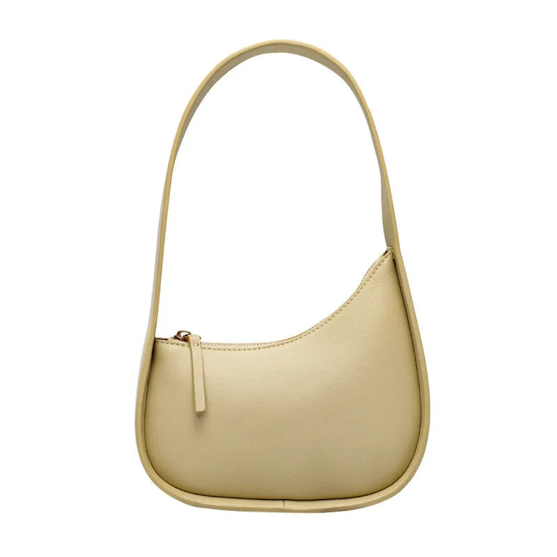 Small half moon shaped leather shoulder bag with wide strap in four colour options