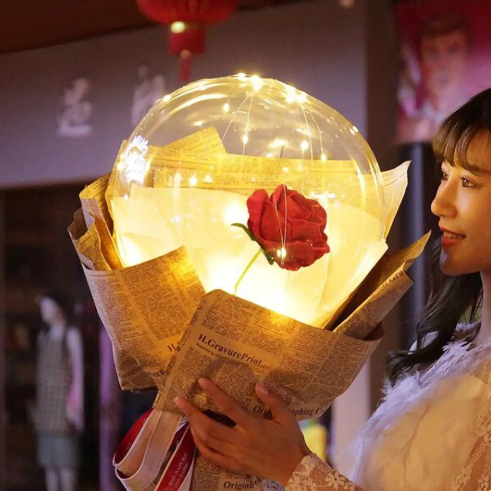 Transparent LED luminous balloon with artificial rose and built-in light, shown as a DIY bouquet kit.