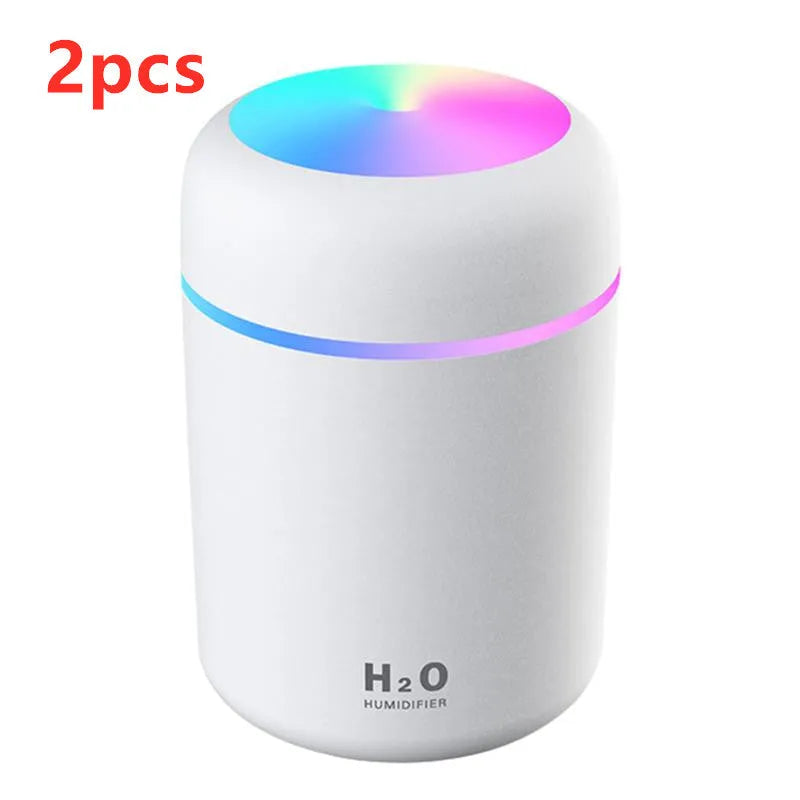 Pink USB portable humidifier with 300ml water tank on wooden desk surface