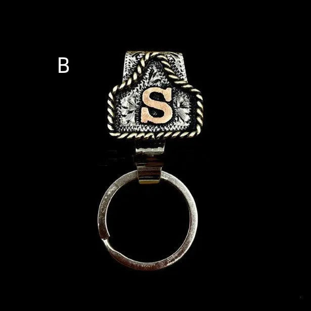 Handmade metal cow tag key holder for belts in assorted colours on a leather strap