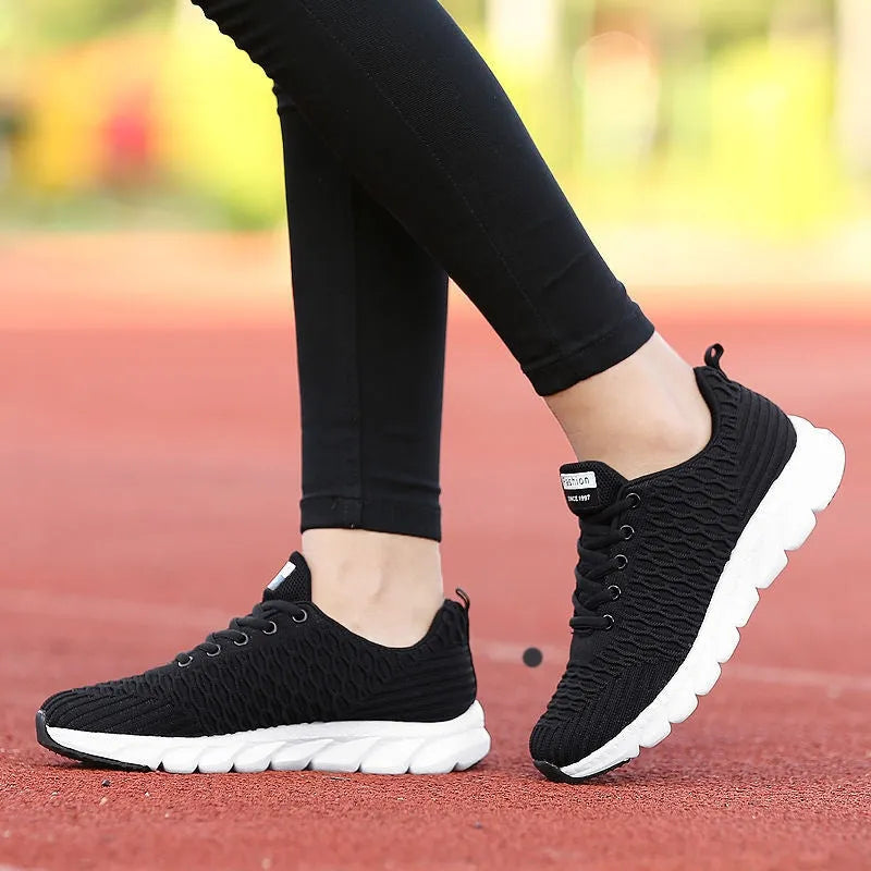 Women's running shoes in black pink white colours with fly weaving upper and wear-resistant outsole
