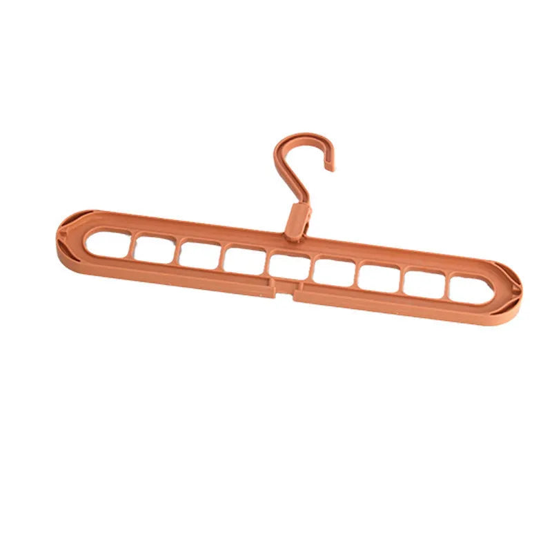 Green plastic nine-hole folding pant hanger for trousers and skirts.