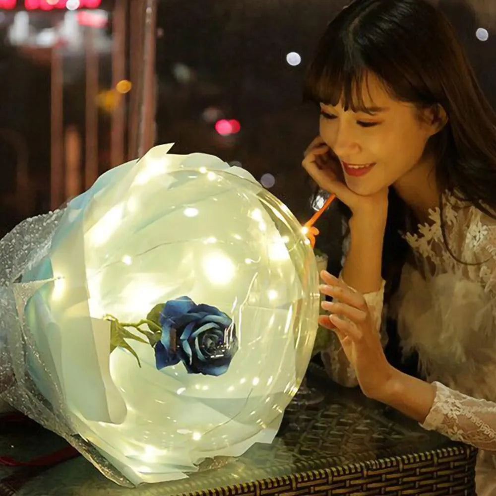 Transparent LED luminous balloon with artificial rose and built-in light, shown as a DIY bouquet kit.