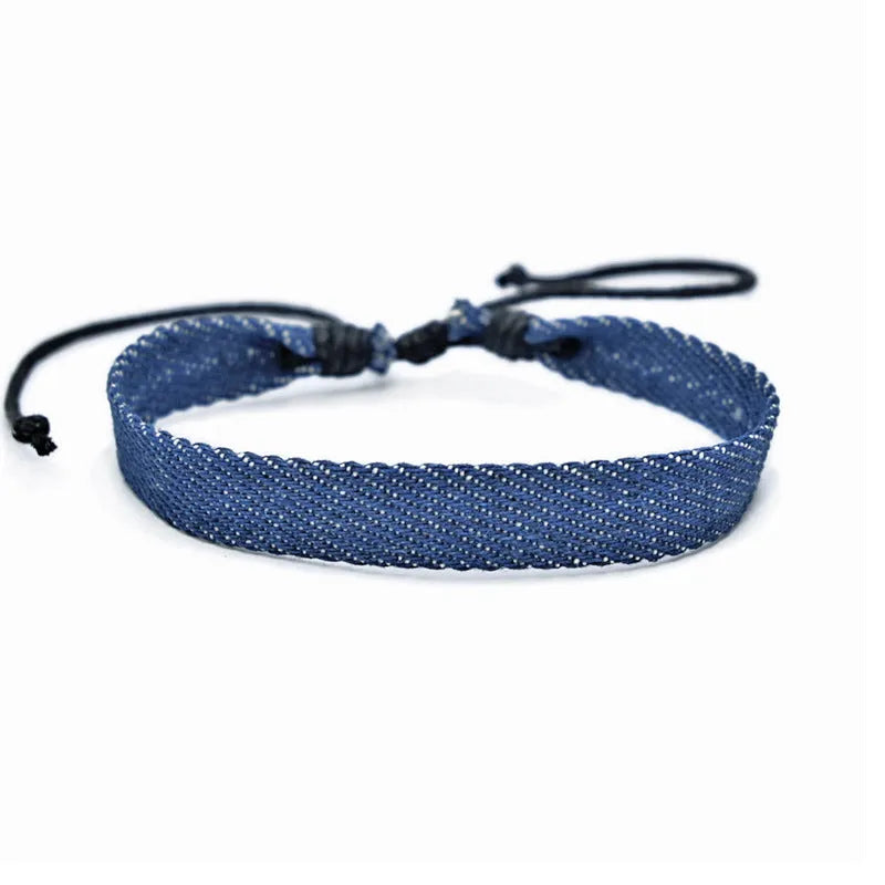 Handmade denim fabric wristband carrying strap in mixed materials with adjustable closure