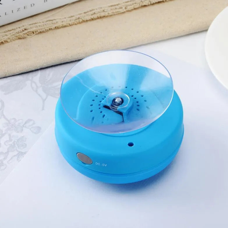 Portable Bluetooth speaker with suction cup showing front speaker grille and side buttons