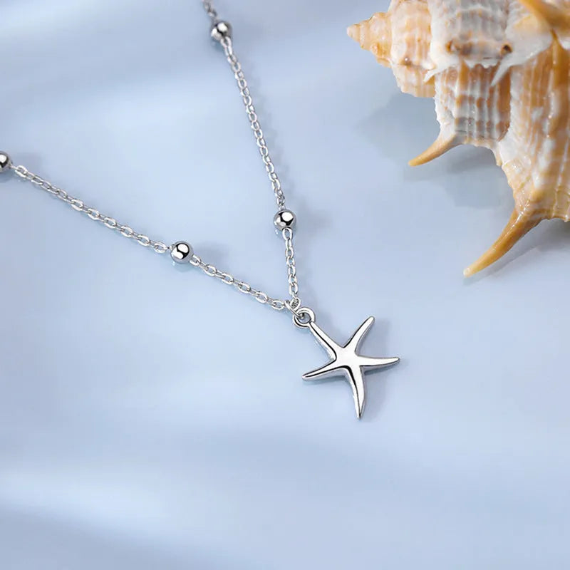S925 sterling silver anklet with a starfish charm and round beads on an adjustable chain.
