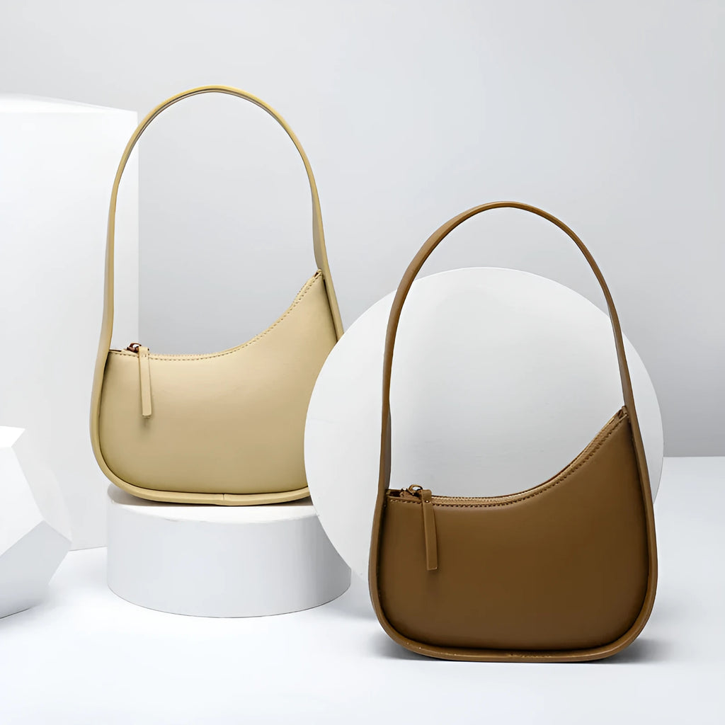 Small half moon shaped leather shoulder bag with wide strap in four colour options