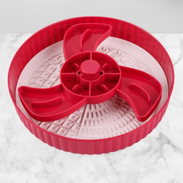 Grey rotating pet slow feeder bowl with a blue silicone windmill-pattern licking mat attached.