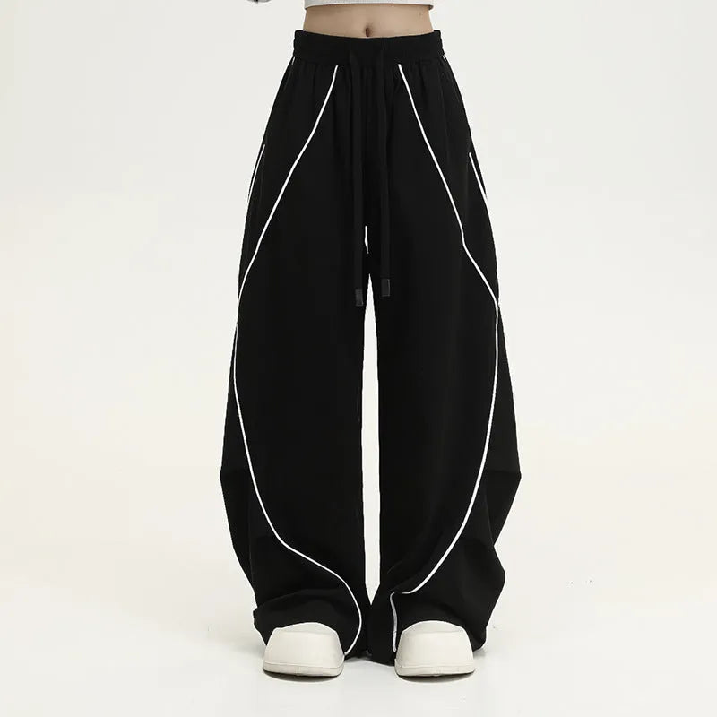 Black striped hip hop sports trousers with pleated wide-leg design on a mid waist