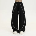Black striped hip hop sports trousers with pleated wide-leg design on a mid waist