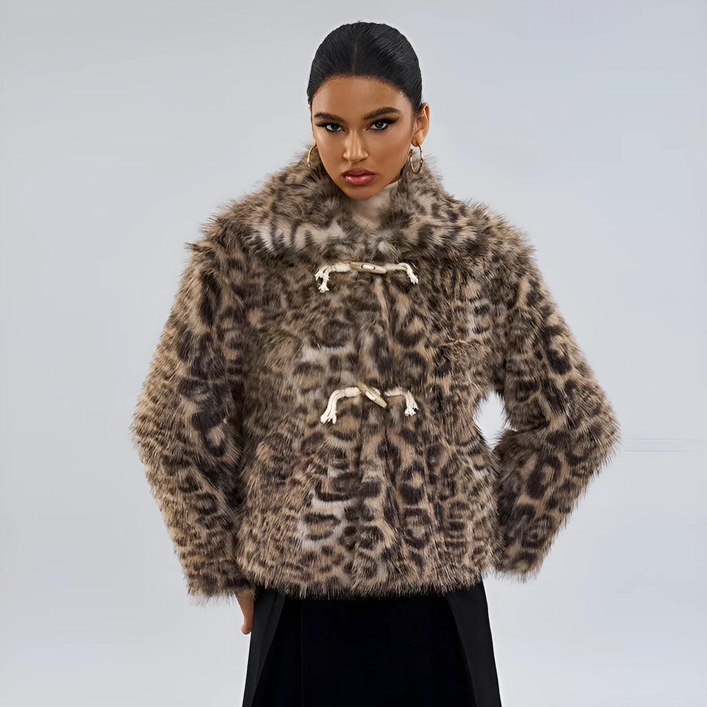 Women's leopard print coat with a buckle lapel fastening, shown in street fashion style.